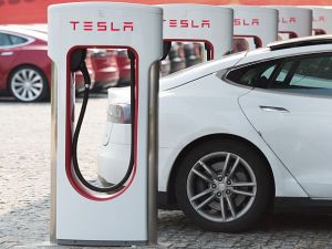 This picture taken on March 17, 2015 shows a Tesla Model S being charged at a car dealership in Shanghai. Serial entrepreneur Elon Musk has launched spacecraft into orbit, but popularising his Tesla electric cars in China is proving to be tougher than rocket science.