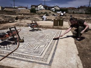 An archaeologist works on a mosaic on July 31, 2017, on the archaeological antiquity site of Sainte-Colombe, near Vienne, eastern France.