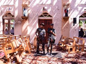 Sri Lankan soldiers look on inside the St Sebastian's Church at Katuwapitiya in Negombo on April 21, 2019, following a bomb blast during the Easter service that killed tens of people. A series of eight devastating bomb blasts ripped through high-end hotels and churches holding Easter services in Sri Lanka, killing nearly 160 people, including dozens of foreigners.