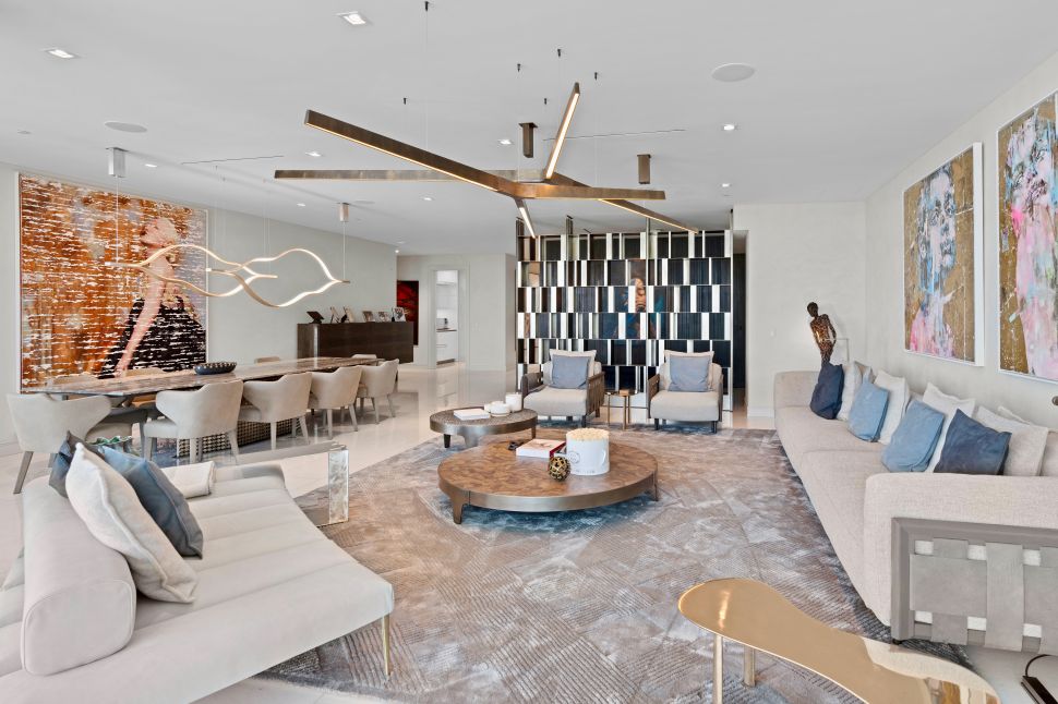 A modern living room in grey and beige tones, with two LED chandeliers.