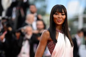British model Naomi Campbell in white dress on red carpet