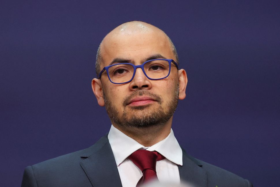 Man in suit wearing blue glasses