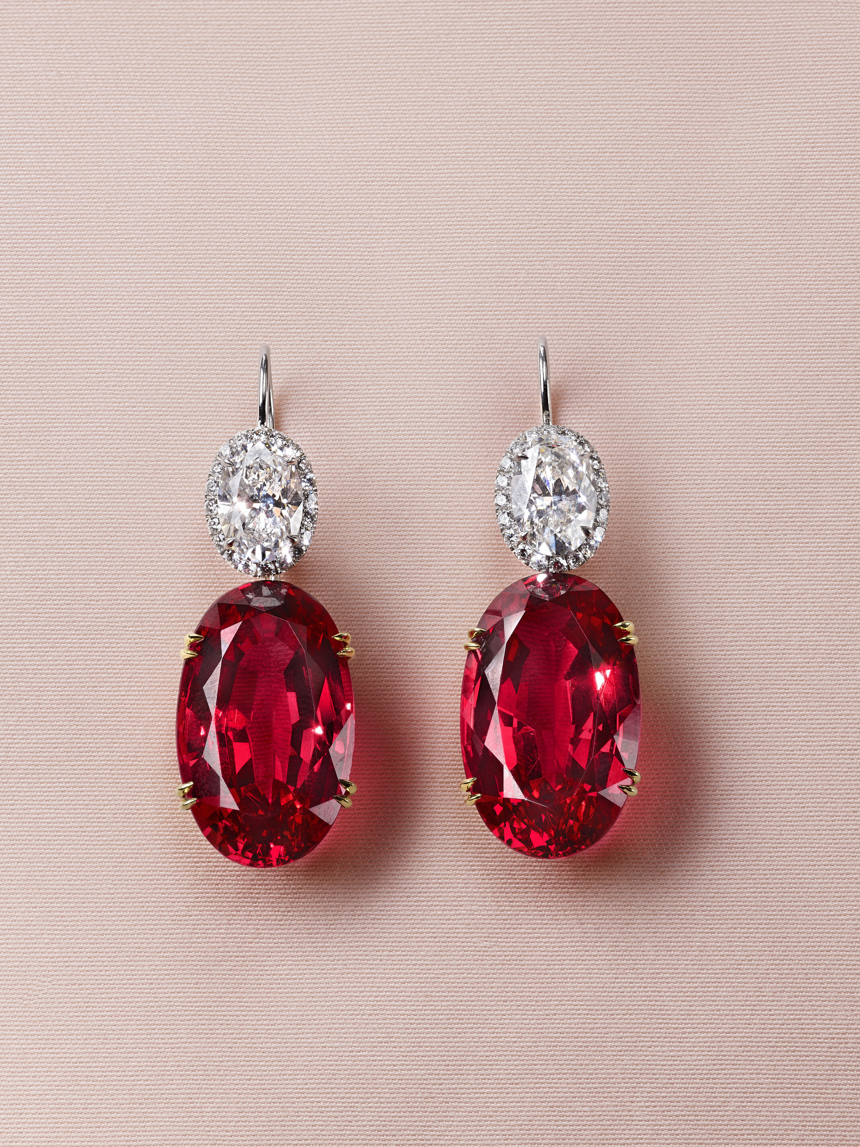 A pair of oval mixed-cut reddish pink spinel earrings