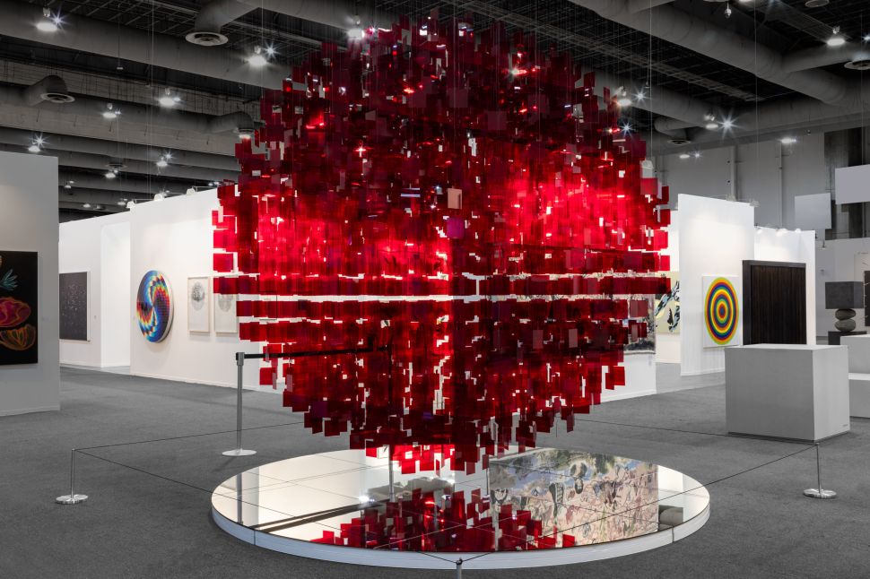 Hanging sculpture made of red prismatic elements floating 