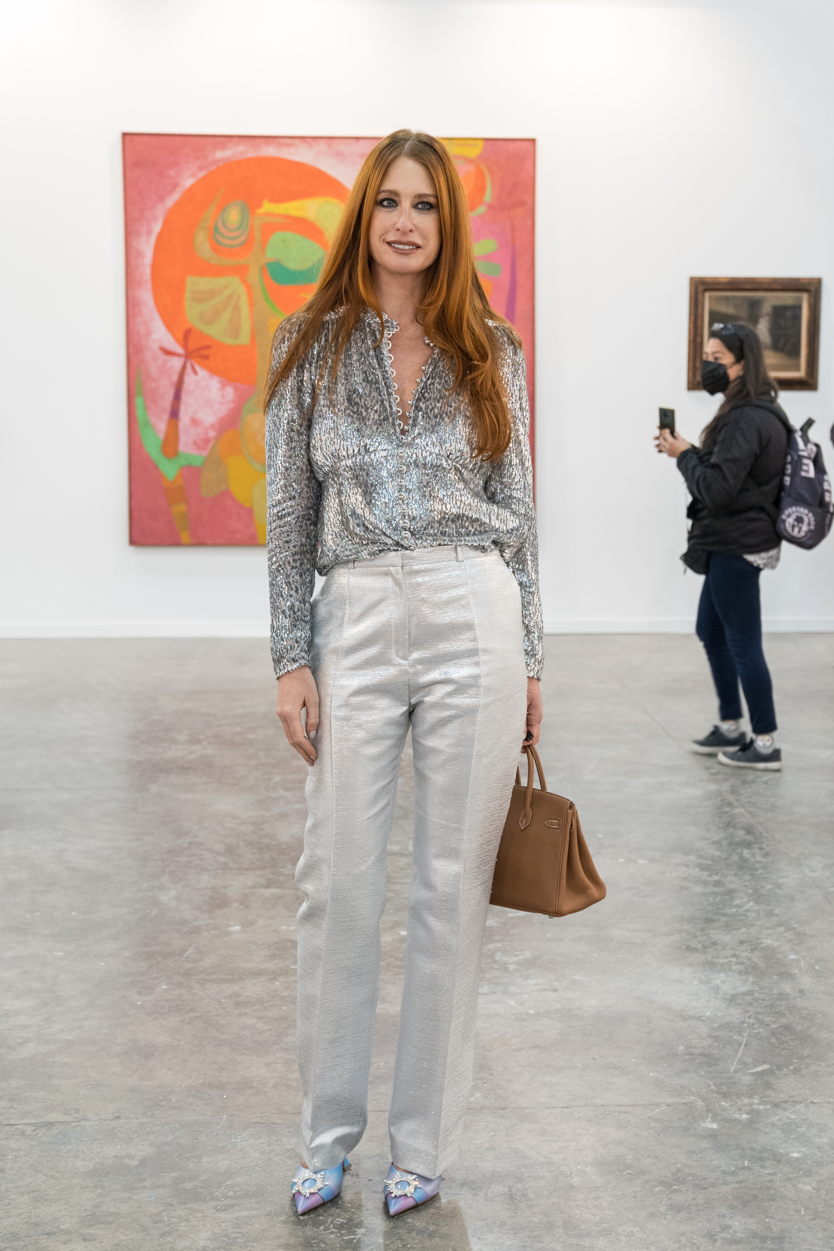 Photo of a young woman with red hairs in an art fair.