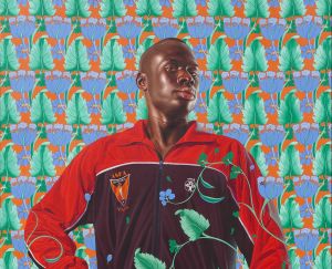 A hyperrealistic painting of a Black man wearing a red and black sports jacket, standing confidently in front of an ornate, brightly patterned floral wallpaper that intertwines with his figure, creating a sense of layered visual complexity.