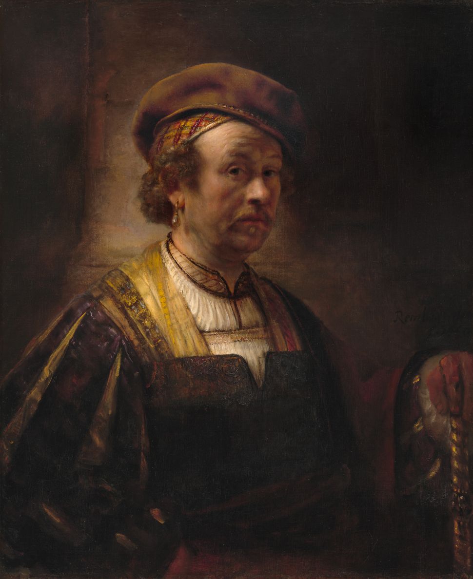 A painting of a man in a robe and hat by Rembrandt's workshop