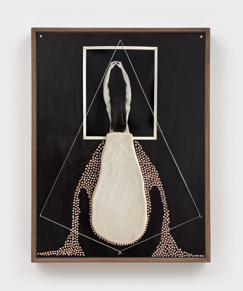An artwork shows a black-and-white photo of a woman’s back with arms raised, framed within a mixed-media composition on black background that includes textured fabric and a constellation of small circular elements forming a triangular structure.